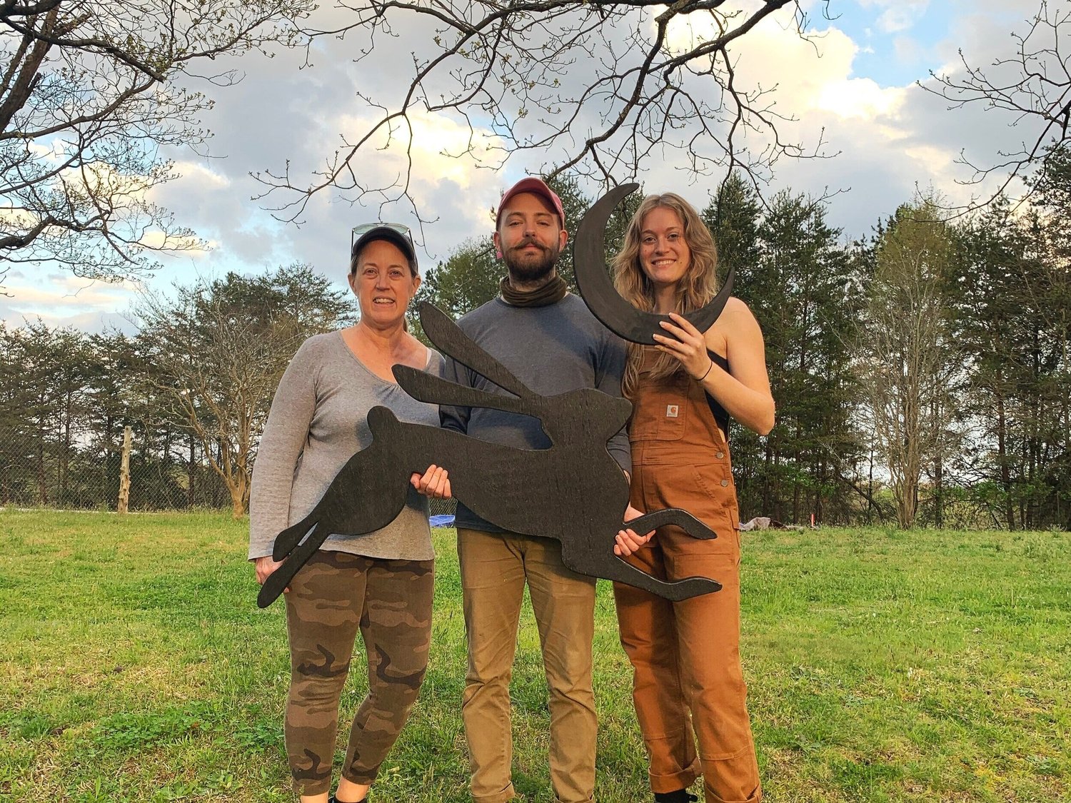 Donna, Elijah and Sarah, the three farmers, holding the Rabbit Crest Farms sign