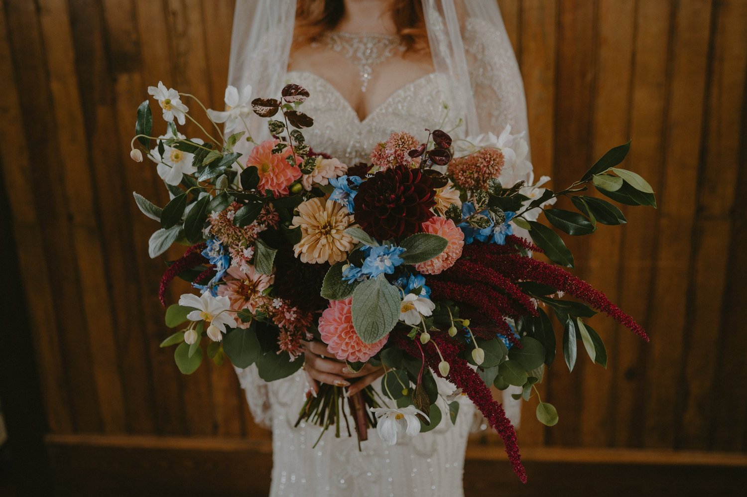 A bride holding a garden-style bouquet of farm-grown flowers